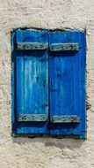 window with blue wooden shutters