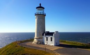 lighthouse on the beautiful and colorful hill near the sea