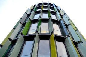 high rise Building with colorful panels on facade at windows