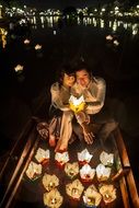 newlyweds on a boat with candles on a boat in Hoian