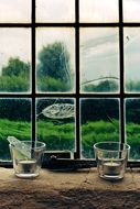 candles in glass glasses near the window