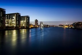 buildings near the river at night in berlin