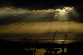 panoramic view of darrk sunset over port cranes