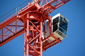 driver's cab on a red construction crane