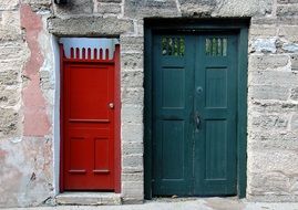 two vintage doors on the stone facade of the building, st augustine, florida