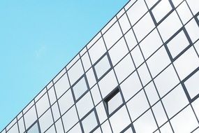 glass facade of the building against the blue sky
