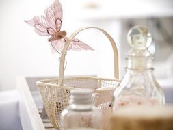 wicker basket with a pink butterfly on the table