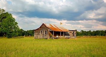 wooden log cabin in a field in Alabama