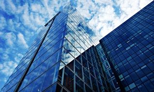 Skyscraper with clear Windows on the white cloudy scene