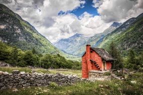 old brick house on a background of mountains in Switzerland