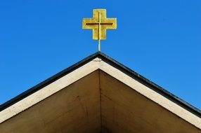 golden cross on an old church