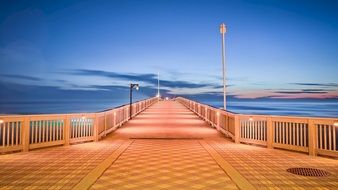 Pier on ocean at night