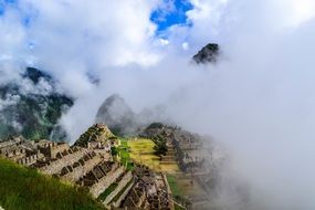 panoramic view of Machu Picchu in a cloudy haze