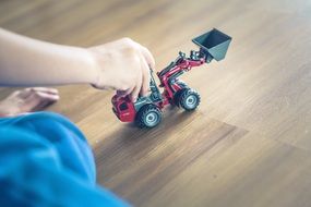 baby excavator in the hands of a boy