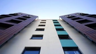 bottom view of the windows on the white facade of the building