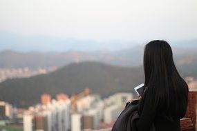 girl with long black hair over the cityscape in China