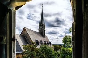 Lost Place, Church spire at cloudy sky