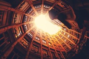 architecture of a well of a city building in the background of bright light