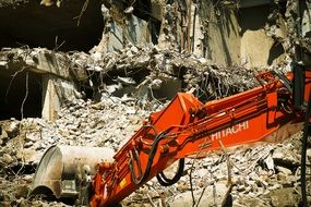 old building demolition by excavator