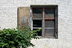 window on the wall with wooden shutters