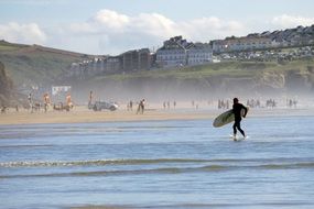 surfer on beautiful sandy Perranporth beach