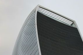 black and white picture of a modern glass skyscraper