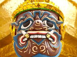 giant face, decoration on the tower of Temple of the Emerald Buddha, thailand, bangkok