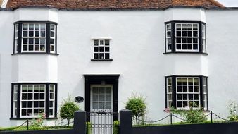 white cottage with black windows