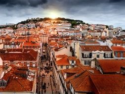 brown tiled roofs under the rays of the evening sun in Lisbon, Portugal