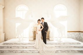 the bride and groom on stairs