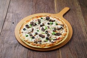 Pizza on the board in the form of a frying pan