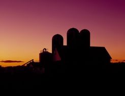 landscape of dairy barn silhouette at dusk