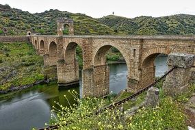 antique stone arch bridge over the river under the protection of UNESCO