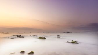 white mist above sea water at dusk