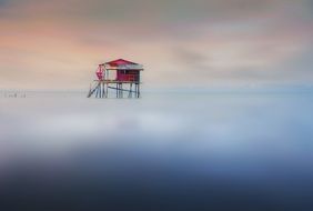 house on the water in the fog