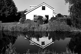 black and white photo of the building on the river bank