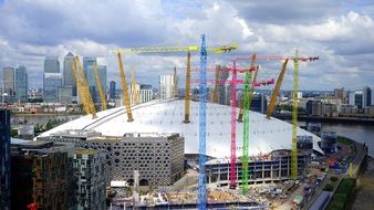 multi-colored construction cranes on the banks of the River Thames in London