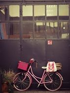 pink Bike at wall in city