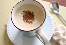 foamed Coffee in Mug on table