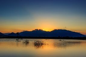 golden dawn over the hills and lake