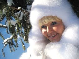 woman in white furs in a winter sunny day