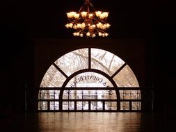 large chandelier on the background of the window