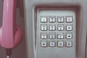 pink telephone in a telephone booth