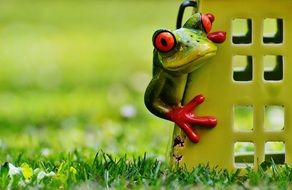 ceramic figurine in the form of a frog near the house
