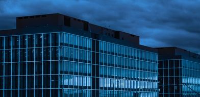 tops of Blue Glass Office Buildings at cloudy sky