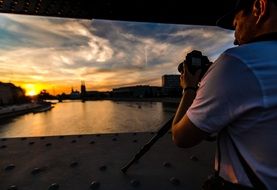 photographer takes pictures of the sunset on polaroid