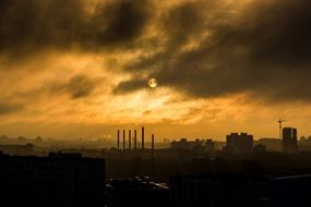 yellow sunset and industrial smoke from a refinery