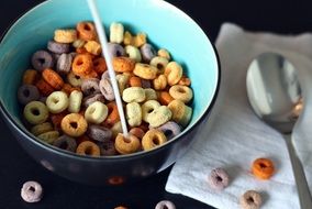 a bowl of colorful breakfast cereal and milk for children