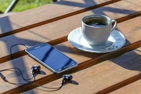 Relaxation, Coffee and Smartphone on table outdoor