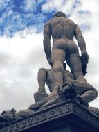 Statue of David at blue sky background with white clouds in Tuscany, Italy